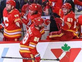 Elias Lindholm and Daniel Vladar of the Calgary Flames celebrates