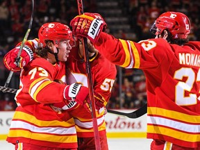 Calgary Flames forward Tyler Toffoli  (left) celebrates after scoring against the Minnesota Wild at Scotiabank Saddledome in Calgary on Saturday, Feb. 26, 2022.