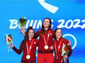 Gold medallists Ivanie Blondin, Valerie Maltais and Isabelle Weidemann of Team Canada show off their medals during the Women's Team Pursuit medal ceremony on Day 11 of the Beijing 2022 Winter Olympic Games.