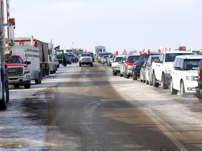 Authorities deal with a new roadblock on Highway 4 and 501 outside of Milk River heading towards the Coutts border crossing. Protesters were letting trucks through on one lane on Thursday, February 3, 2022.