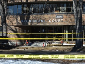 Yellow tape surrounds the Ponoka Provincial Courthouse after a shooting on the front steps where a man in his 40's was shot and flown to an Edmonton hospital for treatment, February 10, 2022.