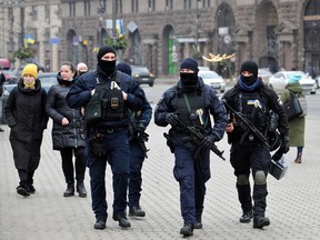 Ukrainian police officers patrol a street in central Kyiv on February 16, 2022.