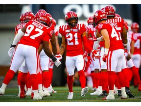 The Calgary Stampeders have re-signed defensive back Raheem Wilson (centre).