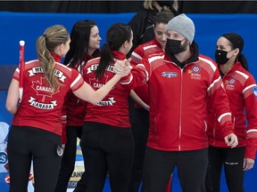 Team Canada coach Reid Carruthers congratulates lead Briane Meilleur, skip Kerri Einarson, third Val Sweeting, second Shannon Birchard and alternate Krysten Karwacki, from left, after defeating Wild Card 1 in Page playoff action at the Scotties Tournament of Hearts at Fort William Gardens in Thunder Bay, Ont., on Saturday, Feb. 5, 2022.