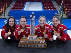 From left, Team Canada skip Kerri Einarson, third Val Sweeting, second Shannon Birchard and lead Briane Meilleur pose with the trophy and medals after winning the Scotties Tournament of Hearts at Fort William Gardens in Thunder Bay, Ont., on Sunday, Feb. 6, 2022.