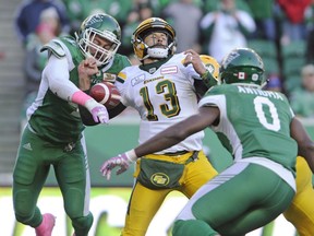 Saskatchewan linebacker Cameron Judge strips the ball from Edmonton quarterback Mike Reilly during CFL action in Regina on Oct. 8, 2018.