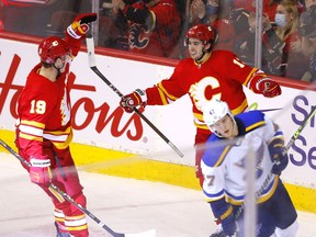 The Calgary Flames’ Johnny Gaudreau (right) celebrates with Matthew Tkachuk after scoring a goal against the St. Louis Blues at Scotiabank Saddledome in Calgary on Monday, Jan. 24, 2022.