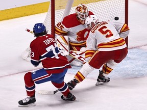 The Montreal Canadiens’ Tyler Toffoli (73) scores against Calgary Flames goaltender Jacob Markstrom as defenseman Mark Giordano defends at the Bell Centre in Montreal on April 16, 2021.