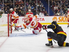 Canucks forward Conor Garland scores on Calgary Flames goalie Dan Vladar in the third period at Rogers Arena in Vancouver on Thursday night. The Canucks won 7-1.