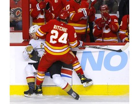 Calgary Flames forward Brett Ritchie crunches Vegas Golden Knights forward William Karlsson in first-period NHL action at the Scotiabank Saddledome in Calgary on Wednesday, February 9, 2022.