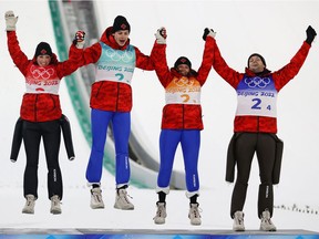 Canadians Alexandria Loutitt, Matthew Soukup, Abigail Strate and Mackenzie Boyd-Clowes celebrate their bronze medal in the ski jumping team event in Zhangjiakou, China, on Monday, Feb. 7, 2022.