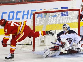 Newest Flames forward Tyler Toffoli scores on Columbus Blue Jackets goalie Elvis Merzlikins in third-period NHL action at the Scotiabank Saddledome in Calgary on Tuesday.