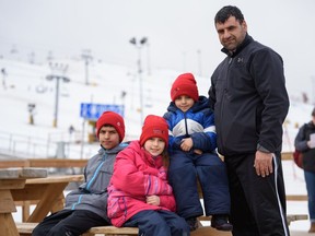 (Left to right) Haseebullah, Freeba, Habibullah, and their father Nangalai Sadat enjoyed a day of fun as they tried snow sports for the first time on Friday, March 25, 2022.