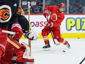 Calgary Flames forward Johnny Gaudreau takes a shot on goaltender Jacob Markstrom during practice at the Scotiabank Saddledome on Monday, March 28, 2022.