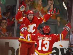 Calgary Flames forward Elias Lindholm celebrates a goal against the Edmonton Oilers with Johnny Gaudreau at Scotiabank Saddledome on Saturday, March 26, 2022.