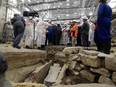 France's Culture Minister Roselyne Bachelot (centre, left) visits the Notre Dame Cathedral archeological research site after the discovery of a 14th century lead sarcophagus, in Paris, on March 15, 2022.