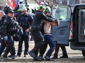 Calgary police make an arrest during an anti mandate and counter protester rally in Central Memorial Park on Saturday, March 19, 2022.
Gavin Young/Postmedia