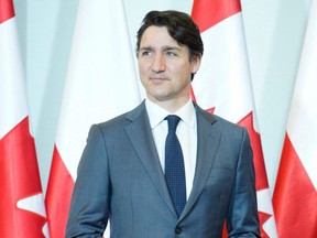 Prime Minister Justin Trudeau poses for a photo prior to talks with his Polish counterpart on the Ukraine-Russia conflict, in Warsaw, Thursday, March 10, 2022.