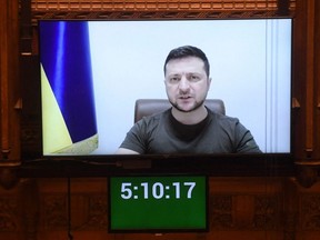 A handout photograph released by the U.K. Parliament shows Ukraine's President Volodymyr Zelenskyy speaking to Britain's MPs by live video-link in the House of Commons, in London, Tuesday, March 8, 2022.