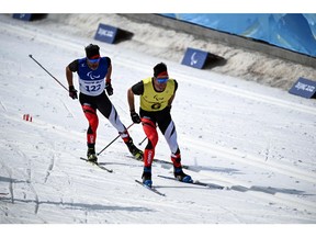 Canada's Brian McKeever (left) and guide Russell Kennedy compete during the men's sprint free vision impaired cross country final on Wednesday at the Zhangjiakou National Biathlon Centre, during the Beijing 2022 Winter Paralympic Games.