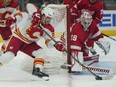 Detroit Red Wings goaltender Alex Nedeljkovic stops a shot from Calgary Flames centre Blake Coleman at Little Caesars Arena in Detroit on Oct. 21, 2021.