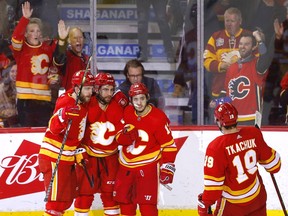 The Calgary Flames celebrate a goal by Dillon Dube against the New Jersey Devils at Scotiabank Saddledome in Calgary on Wednesday, March 16, 2022.