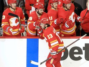 Calgary Flames forward Johnny Gaudreau of the celebrates with teammates after scoring his 200th NHL goal during a game against the Arizona Coyotes at Scotiabank Saddledome in Calgary on Friday, March 25, 2022.