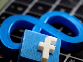 3D-printed images of logos of Facebook parent Meta Platforms and of Facebook are seen on a laptop keyboard in this illustration taken on November 2, 2021.