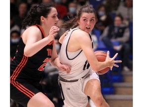 Forward Tanis Metcalfe dives the basket during the first half of action as the Mount Royal Cougars host Thompson Rivers Wolfpack in the Canada West women's quarterfinal playoff game on March 4, 2022.