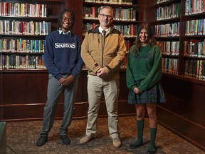 Strathcona-Tweedsmuir School teacher Lennard Fink was photographed with students Bolu Kasumu, left, and Alia Nanji at the school on Tuesday.