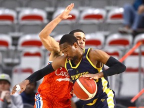 The Edmonton Stingers’ Jahmal Jones battles the Cangrejeros’ Angel Rodriguez during their Basketball Champions League Americas game at WinSport’s Markin MacPhail Centre in Calgary on Monday, March 14, 2022.