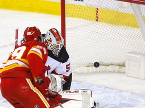 Flames forward Dillon Dube scores on New Jersey Devils goalie Nico Daws in second-period NHL action at the Scotiabank Saddledome in Calgary on Wednesday night.