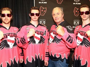Wrestling icon Bret 'Hitman' Hart is joined by Hitmen hockey players Cael Zimmerman, Riley Fiddler-Schultz and Sean Tschigerl in unveiling a special jersey to be worn at the Bret 'Hitman' Hart game on Saturday at the Saddledome.