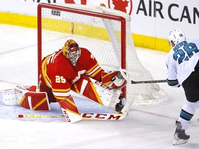 Calgary Flames goalie Jacob Markstrom stops the San Jose Sharks' Timo Meier in third-period NHL action at the Scotiabank Saddledome in Calgary on Tuesday.