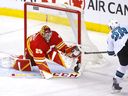 Calgary Flames goalie Jacob Markstrom stops San Jose Sharks forward Timo Meier  at Scotiabank Saddledome in Calgary on March 22, 2022. 