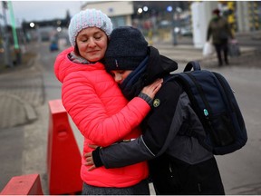 Ukrainian family members hug each other, after fleeing the Russian invasion of the country, at the border checkpoint in Medyka, Poland, March 2, 2022.