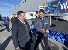 Premier Jason Kenney speaks with Walmart Canada CEO Horacio Barbeito, as the company formally  announces its new fulfilment centre near Balzac, north of Calgary, on Monday, March 21, 2022.