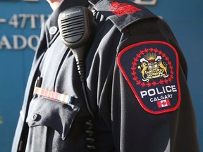 A Calgary police officer displays the shoulder badge introduced in 2019.