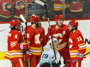 The Calgary Flames celebrate a goal against the Seattle Kraken at the Scotiabank Saddledome on Tuesday, April 12, 2022.