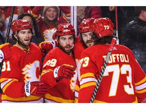 Dillon Dube #29 (C) of the Calgary Flames celebrates with his teammates after scoring against the Vegas Golden Knights during the first period of an NHL game at Scotiabank Saddledome on April 14, 2022 in Calgary, Alberta, Canada.