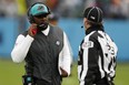 Head coach Brian Flores of the Dolphins talks with line judge Mike Dolce #123 during the fourth quarter against the Titans at Nissan Stadium in Nashville, Jan. 2, 2022.