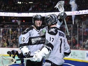 The Calgary Roughnecks’ Tanner Cook (left) celebrates with teammate Curtis Dickson during their win against the Panther City Lacrosse Club on WestJet Field at Scotiabank Saddledome in Calgary on Saturday, April 9, 2022.