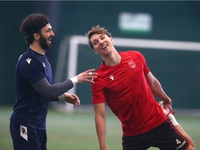 Cavalry FC keeper Marco Carducci (L) and Dean Klomp share a laugh during practice at the Macron Performance Centre in Calgar on Monday, April 4, 2022.