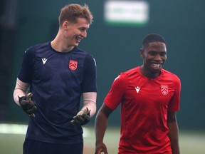 Cavalry FC keeper Julian Roloff (L) and Elijah Adekugbe share a laugh during practice at the Macron Performance Centre in Calgar on Monday, April 4, 2022.