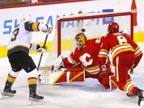 Calgary Flames goalie Jacob Markstrom is scored on by Vegas Golden Knights Evgenii Dadonov in second period NHL action at the Scotiabank Saddledome in Calgary on Thursday, April 14, 2022.