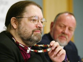 Anglican Church of Canada Primate Archbishop Andrew Hutchison (right) looks on as Bishop Mark MacDonald talks about his aboriginal dentalia shell necklace during a news conference in Toronto, Jan. 4, 2007.
