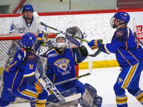 Calgary Royals goaltender Spencer Borsos gets ready to scoop a Northern Alberta Xtreme shot during the Mac’s International Hockey Tournament at Father David Bauer Arena in Calgary on Wednesday, April 6, 2022.