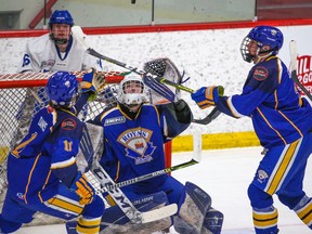 Calgary Royals goaltender Spencer Borsos gets ready to scoop a Northern Alberta Xtreme shot during the Mac's International Hockey Tournament at Father David Bauer Arena in Calgary on Wednesday, April 6, 2022.