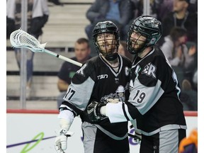The Calgary Roughnecks' Curtis Dickson and Jesse King celebrate a goal against the Halifax Thunderbirds in National Lacrosse League action in Calgary on Friday, April 8, 2022.