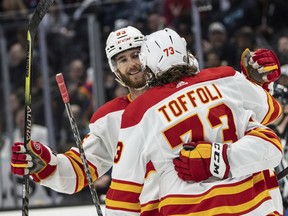 Calgary Flames defenceman Noah Hanifin, left, and forward Tyler Toffoli celebrate a goal against the Seattle Kraken at Climate Pledge Arena in Seattle on Saturday, April 9, 2022.